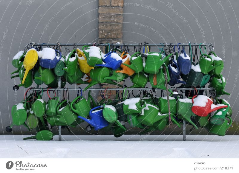 wintery jug chaos Winter Snow Wall (barrier) Wall (building) Watering can Stone Concrete Metal Plastic Lock Cold Blue Yellow Gray Red Cemetery Chaos Muddled