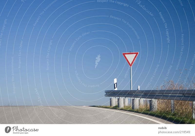 right of way Cloudless sky Deserted Traffic infrastructure Road traffic Street Crossroads Road sign Sign Signage Warning sign Sharp-edged Dry Blue Gray Red