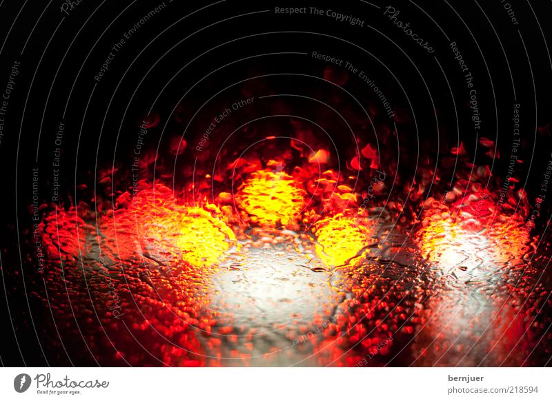 blurry vision Traffic jam Rain Rainwater Drops of water Windscreen Window pane Brake light Transport Highway Abstract Stand Motor vehicle Red Yellow Rear light