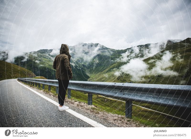 Girl is standing on a road right trough the alps Lifestyle Leisure and hobbies Vacation & Travel Trip Adventure Far-off places Freedom Expedition Camping Winter