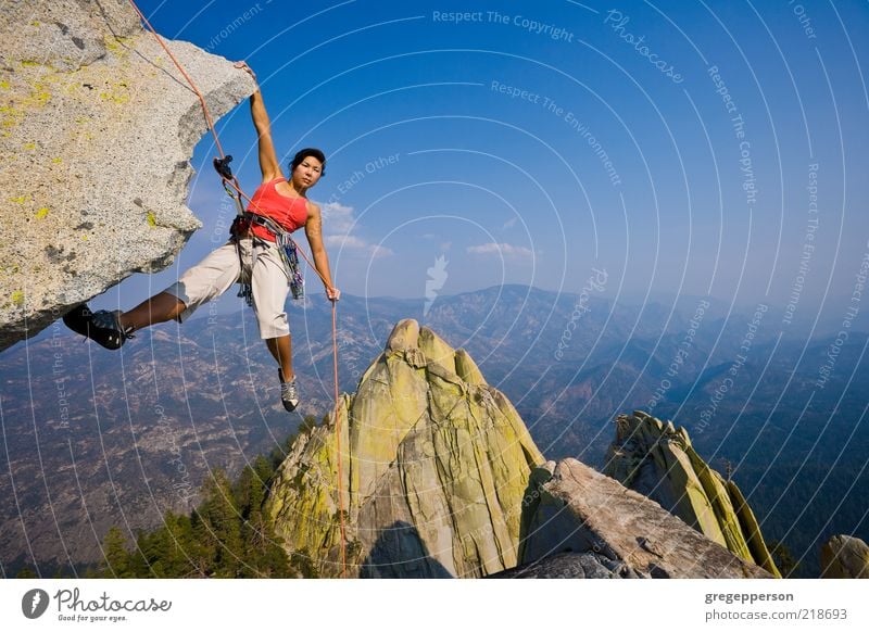 Female rock climber rappelling. Adventure Climbing Mountaineering Rope Young woman Youth (Young adults) 1 Human being 18 - 30 years Adults Athletic Tall