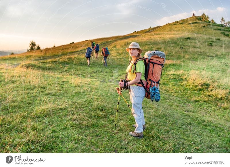 Young woman hiking with friends Lifestyle Wellness Leisure and hobbies Vacation & Travel Tourism Trip Adventure Freedom Camping Summer Summer vacation Mountain