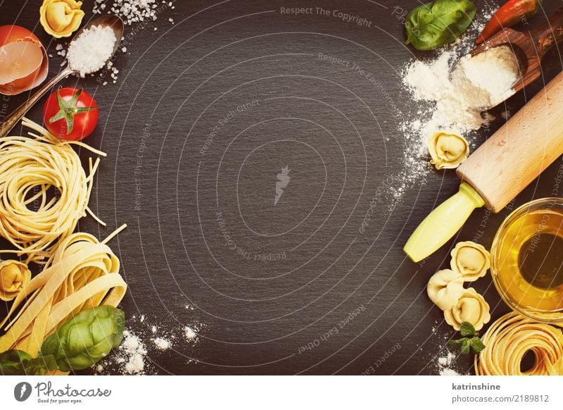 Fresh pasta and ingredients on a dark board top view Bottle Dark Yellow Red Basil Carbohydrate Cooking Dry Egg Flour Food Healthy Home-made Ingredients Italian