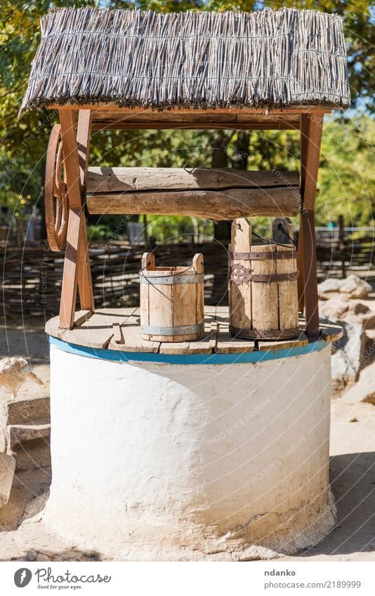 ancient well with drinking water Summer Garden Nature Village Stone Wood Metal Rust Old Historic Retro Green Tradition draw-well Ancient Bucket background