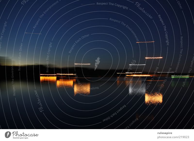 moving lights Calm Summer Ocean Island Nature Water Cloudless sky Night sky Horizon Coast Bay Baltic Sea Als Dyvig Harbour Blue Black Colour photo Multicoloured