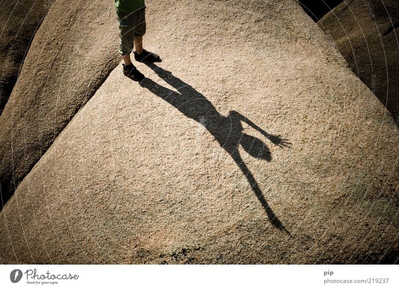 shadow cast Human being Boy (child) Feet Legs 1 Summer Beautiful weather Rock Stone Stand Happy Brown Joy Happiness Unwavering Curiosity Granite Sign language