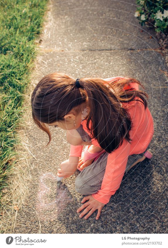 Young girl with brown hair is playing outside. Happy Beautiful Playing Summer Sun Human being Woman Adults Art Flower Graffiti Cute Pink Safety Colour artistic