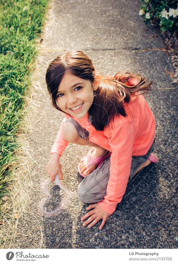 Young girl with brown hair is playing outside. Happy Beautiful Playing Summer Sun Human being Woman Adults Art Flower Graffiti Cute Pink Safety Colour artistic