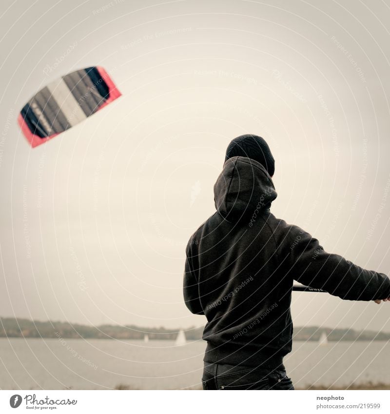 lift-off Sports Kiter 1 Human being Nature Lake lake cospuden Flying Autumn Wind Subdued colour Exterior shot Copy Space top Neutral Background Day Rear view