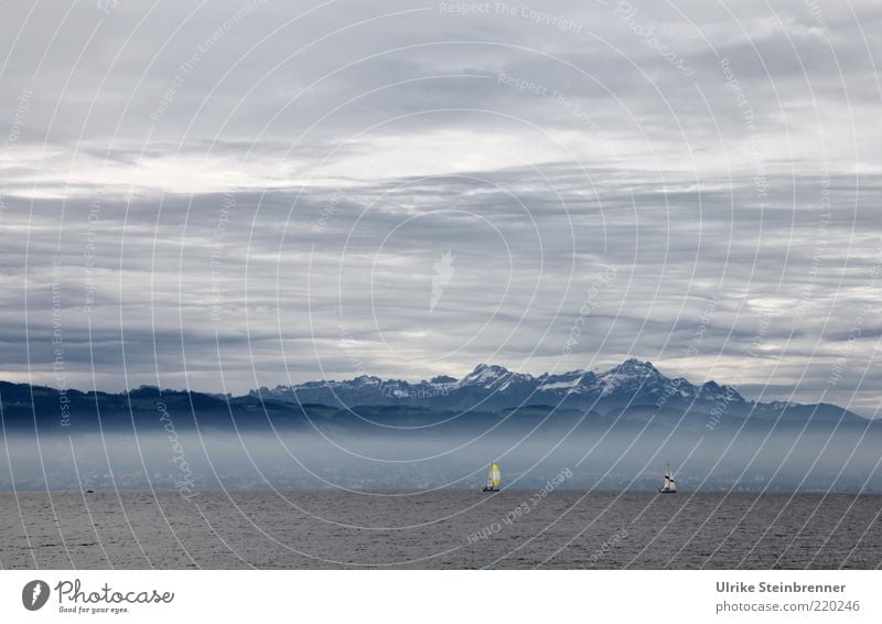 View of the Swiss Alps from the German shore of Lake Constance Water Sailing ship Mountain Sky Clouds Mountain range Blue Air Elements Fog White Gray Covered