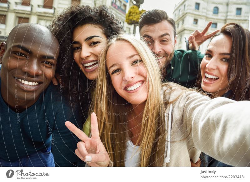 Multiracial group of friends taking selfie in a urban street with a blonde woman in foreground Lifestyle Joy Leisure and hobbies Vacation & Travel Human being