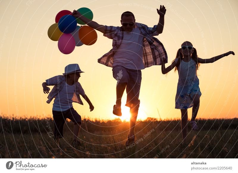 Father and children running on the road at the sunset time. Concept of happy family. Lifestyle Joy Happy Leisure and hobbies Vacation & Travel Adventure Freedom