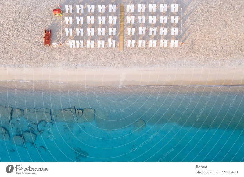 Deckchairs on a sand beach at the turquoise blue sea from above Lifestyle Exotic Relaxation Swimming & Bathing Vacation & Travel Tourism Trip Adventure