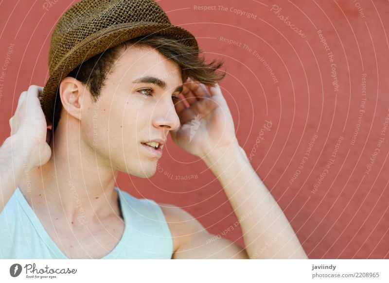 Young man in urban background wearing a sun hat Lifestyle Style Happy Beautiful Human being Boy (child) Man Adults Street Fashion T-shirt Hat Cool (slang) Fresh