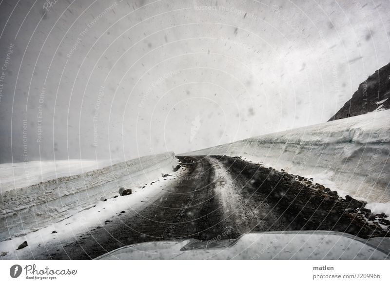 left bend Landscape Clouds Spring Bad weather Snow Snowfall Hill Rock Mountain Driving Car Hood iland Iceland Westfjord Curve Black & white photo Interior shot