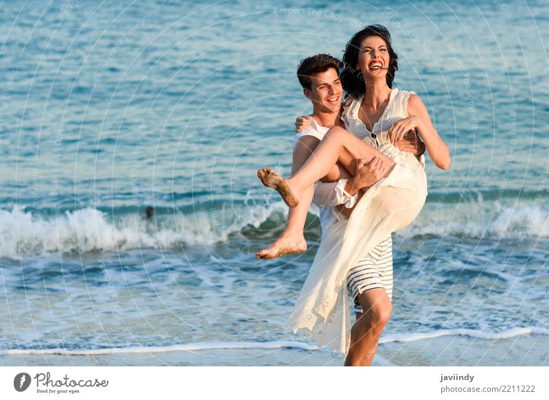 Young happy couple walking in a beautiful beach. Lifestyle Joy Happy Beautiful Hair and hairstyles Vacation & Travel Summer Beach Ocean Human being Woman Adults