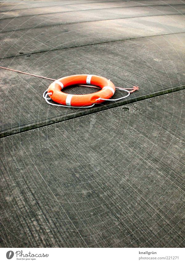 lifesavers Life belt Lie Round Gray Safety Hope Rescue Survive Orange SOS Colour photo Exterior shot Deserted Copy Space top Copy Space bottom Day Light Shadow