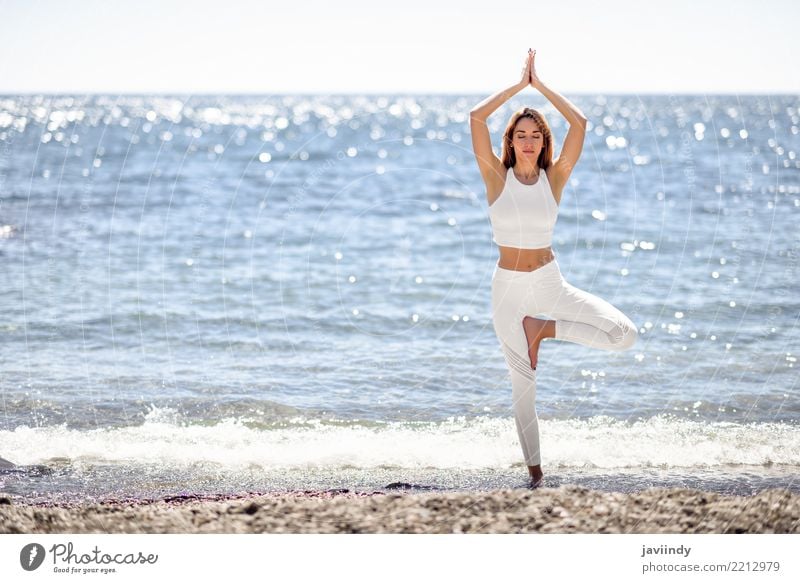 Young woman doing yoga in the beach. Lifestyle Beautiful Wellness Relaxation Meditation Summer Beach Ocean Sports Yoga Human being Woman Adults Nature Fitness