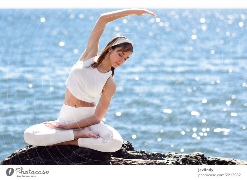 Young woman doing yoga in the beach. Lifestyle Beautiful Wellness Relaxation Meditation Summer Beach Ocean Sports Yoga Human being Feminine Woman Adults 1