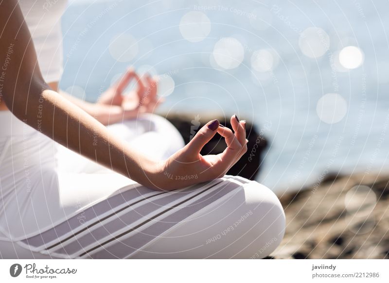 Young woman doing yoga in the beach. Lifestyle Beautiful Wellness Relaxation Meditation Summer Beach Ocean Sports Yoga Human being Woman Adults Hand 1 Nature