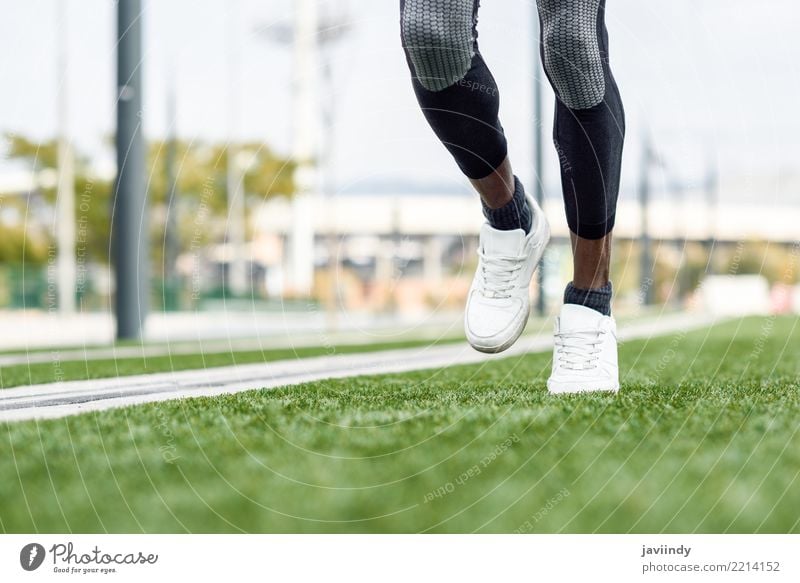 Feet of black man starting running in urban background. Lifestyle Sports Jogging Human being Man Adults Sneakers Fitness Muscular Black african leg athlete