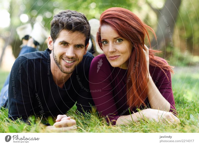 Beautiful young couple laying on grass in an urban park. Lifestyle Joy Happy Summer Human being Masculine Feminine Woman Adults Man Couple 2 18 - 30 years