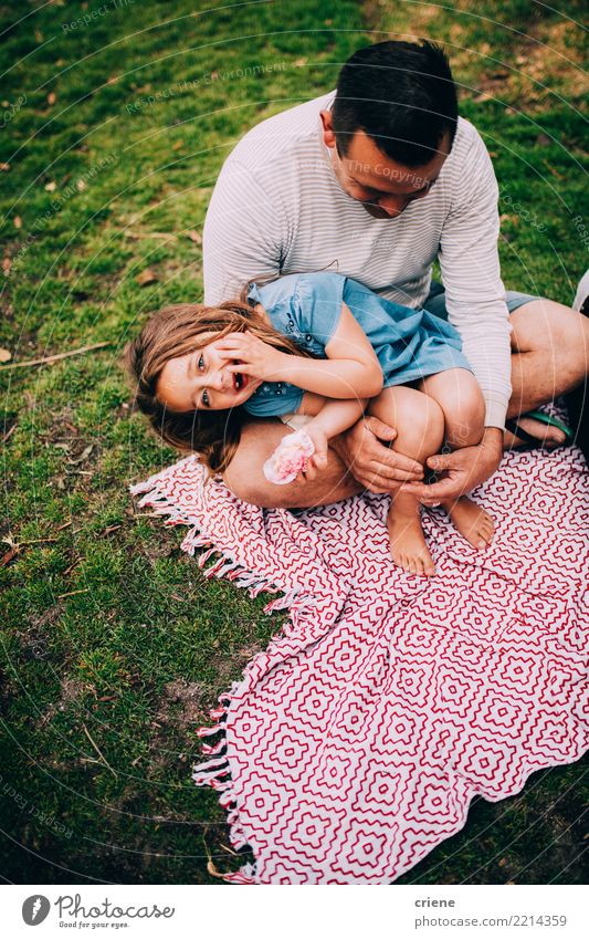 Little girl having fun in the park with her dad Eating Lifestyle Joy Happy Leisure and hobbies Garden Child Girl Man Adults Parents Father Family & Relations