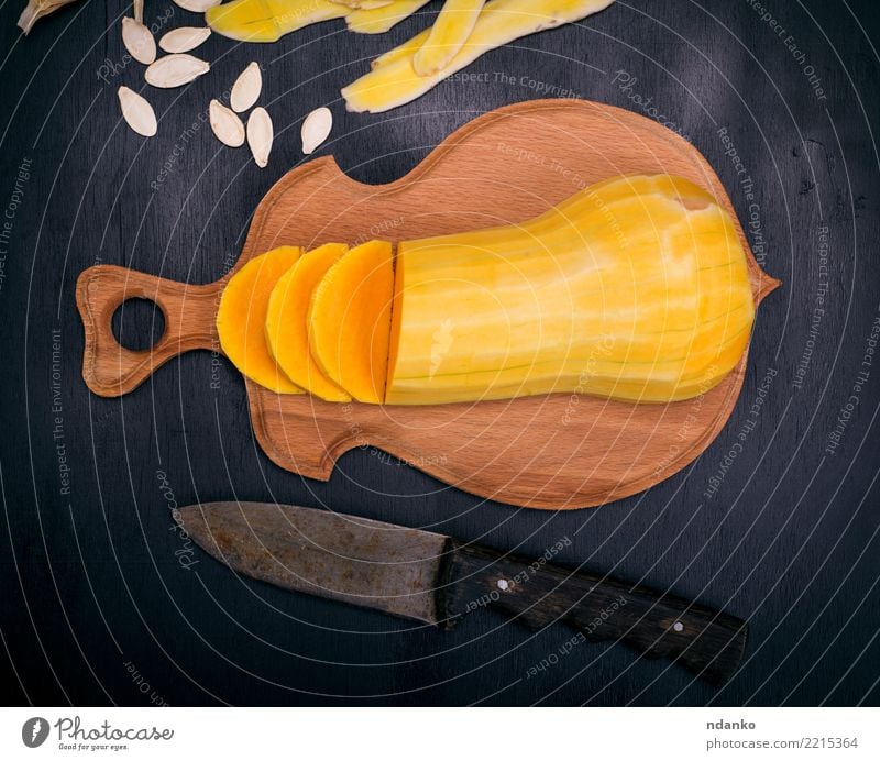 sliced fresh peeled pumpkin Vegetable Eating Dinner Vegetarian diet Knives Table Hallowe'en Nature Wood Fresh Above Yellow Black Tradition Pumpkin food healthy