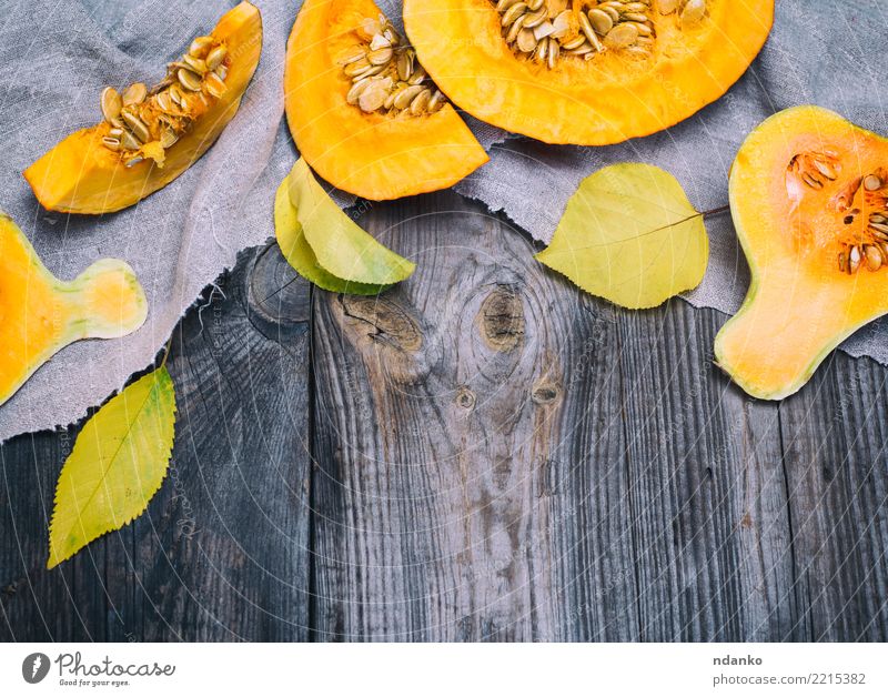 half a fresh pumpkin Vegetable Eating Dinner Organic produce Vegetarian diet Table Hallowe'en Autumn Wood Fresh Above Yellow Gray Tradition Pumpkin food healthy