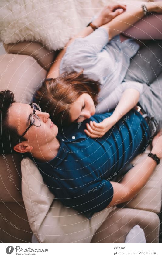 Couple laying on couch watching TV together Joy Happy Relaxation Leisure and hobbies House (Residential Structure) Living room Human being Young woman