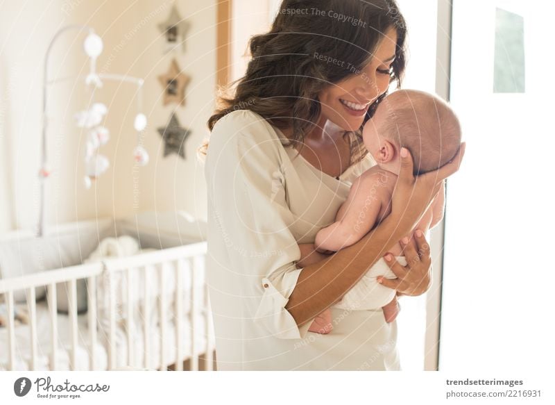 Young mother holding her baby in the bedroom Happy Beautiful Bedroom Child Baby Boy (child) Woman Adults Parents Mother Family & Relations Infancy Love Sleep