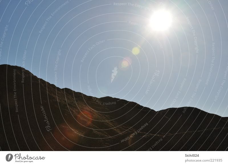 Sand pit in the backlight Landscape Earth Sky Cloudless sky Horizon Sun Sunlight Summer Beautiful weather Warmth Rock Mountain Sandbox naturally Blue Brown