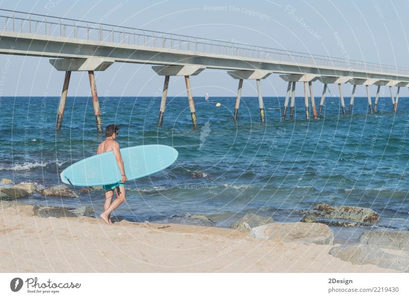 Young attractive surfer holding his surfboard at the beach Lifestyle Joy Vacation & Travel Summer Sun Beach Ocean Waves Sports Man Adults Youth (Young adults)