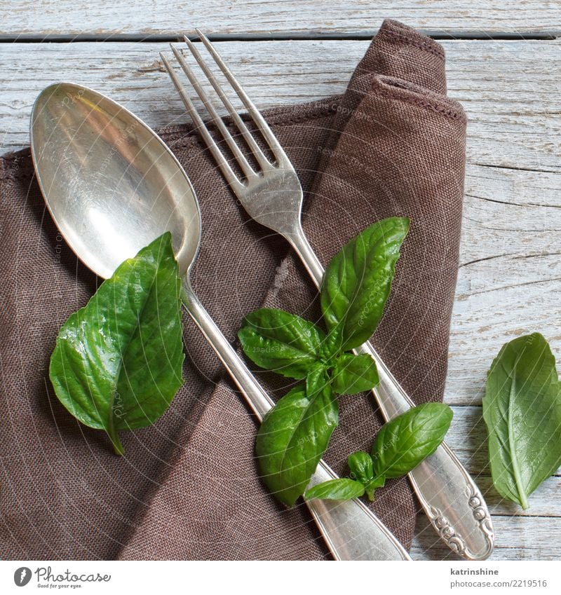 Vintage fork and knife on a napkin on wooden table Dinner Cutlery Fork Design Table Feasts & Celebrations Places Old Dark Bright Retro Brown Green Arrangement