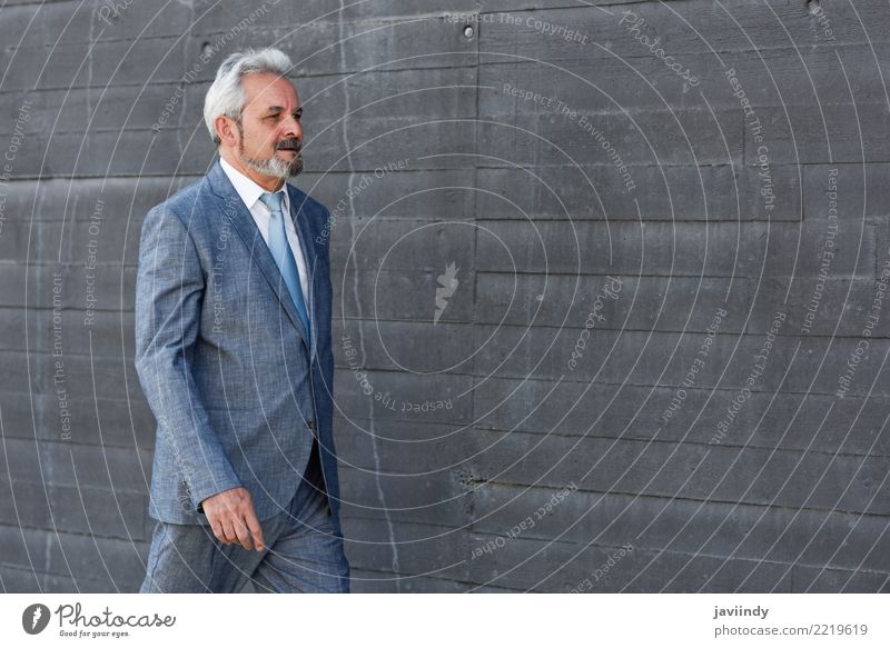 Senior businessman walking outside of modern office building. Elegant Happy Office Business Human being Man Adults Male senior Arm 1 45 - 60 years Building Suit