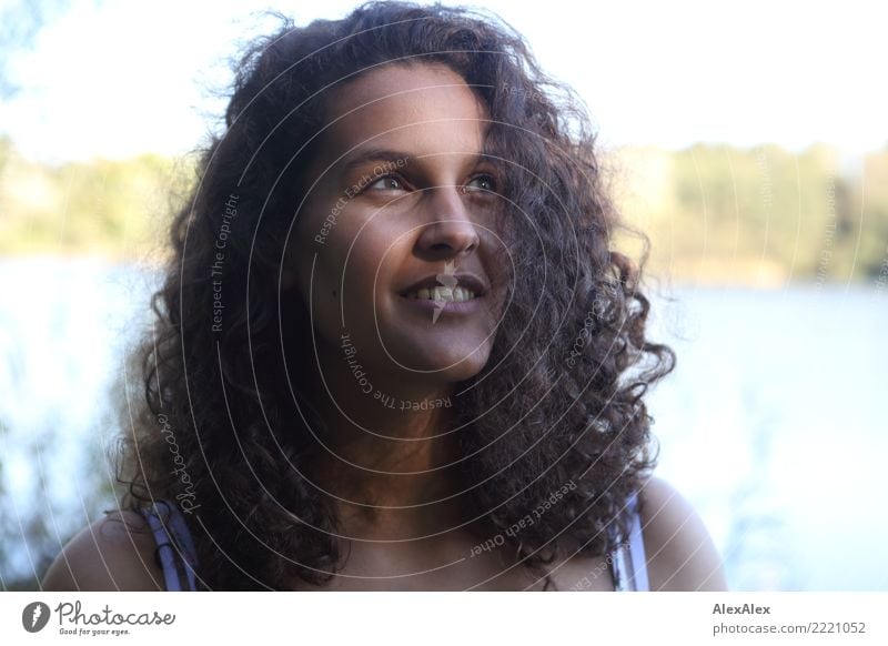 Portrait of tall beautiful woman with long dark curly hair in nature pretty Life Contentment Young woman Youth (Young adults) 18 - 30 years Adults Landscape