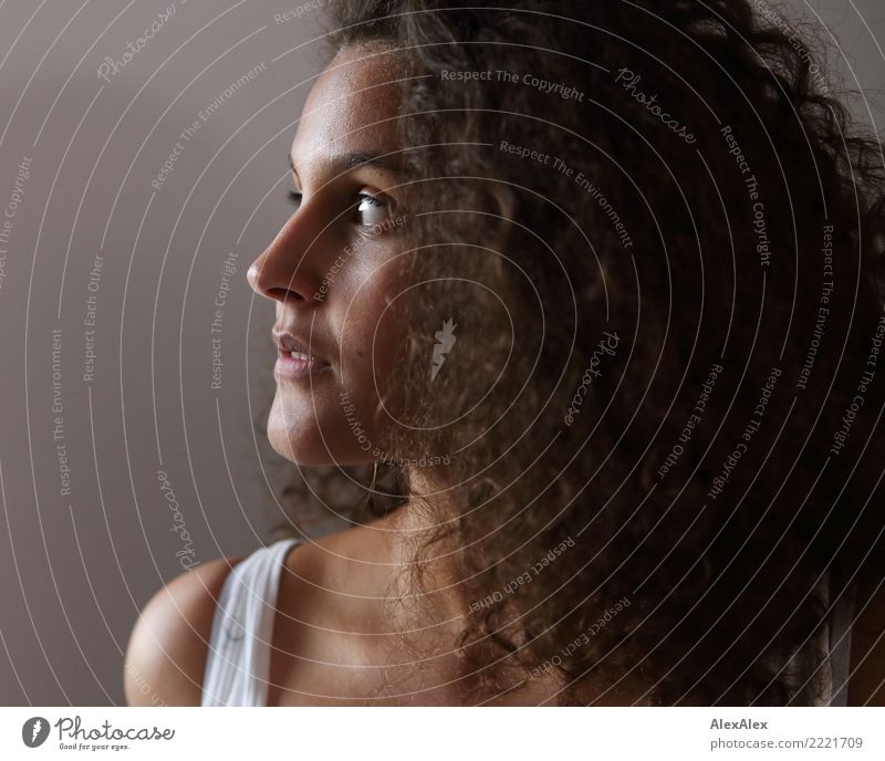 Side portrait of young beautiful woman with long curly hair pretty Hair and hairstyles Face Young woman Youth (Young adults) 18 - 30 years Adults Brunette