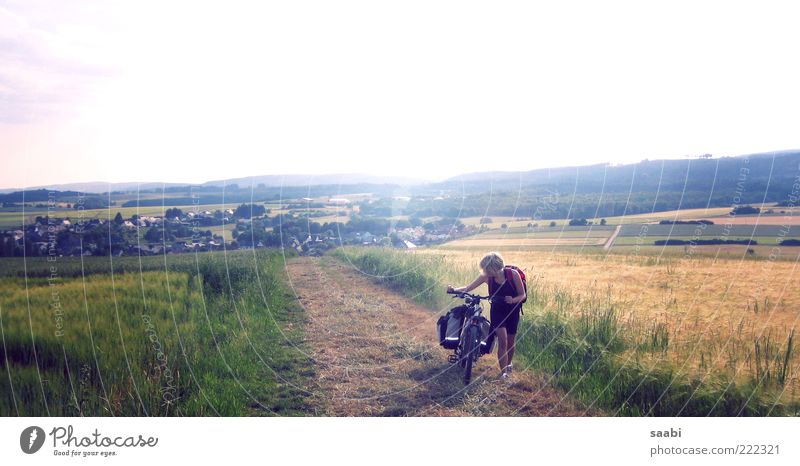 Who loves his bike - pushes. 1 Human being Nature Landscape Sky Summer Beautiful weather Meadow Field Hill Village Cycling Brave Exhaustion Adventure Movement