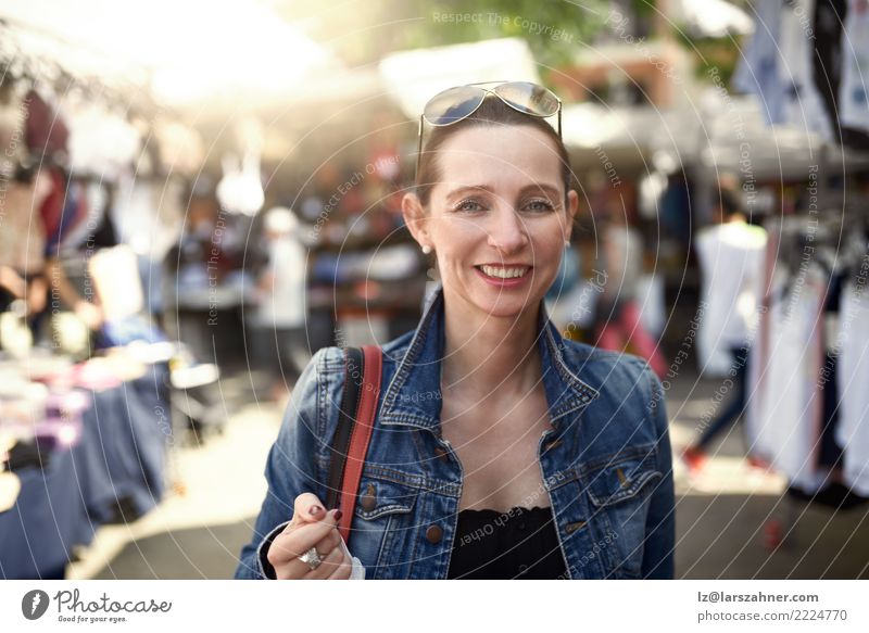 Happy woman shopping at an outdoor market Shopping Face Leisure and hobbies Vacation & Travel Tourism Summer Woman Adults 1 Human being 30 - 45 years Warmth