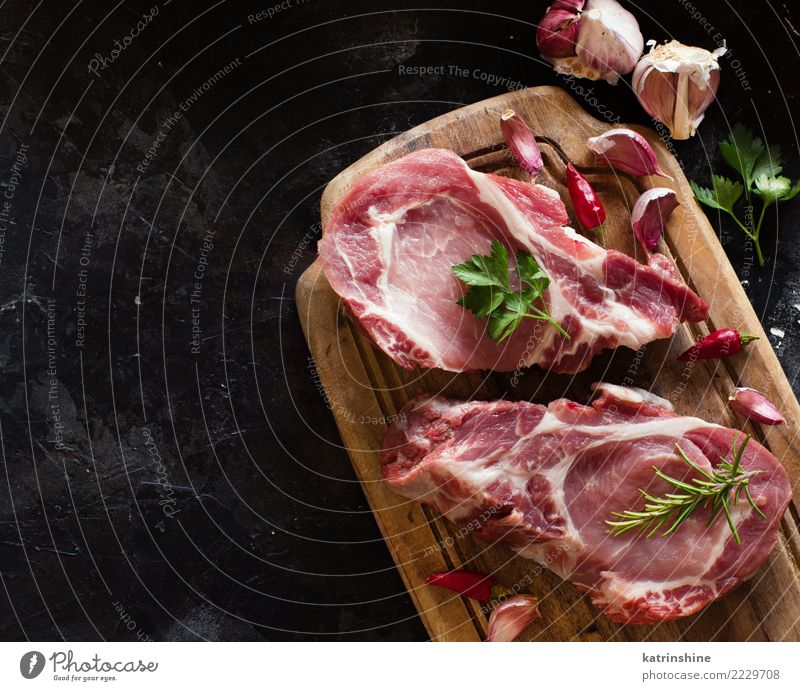 Raw pork steaks called capicola with vegetables and herbs Meat Vegetable Herbs and spices Nutrition Dinner Fresh Above Green Red capicolla board butcher cooking