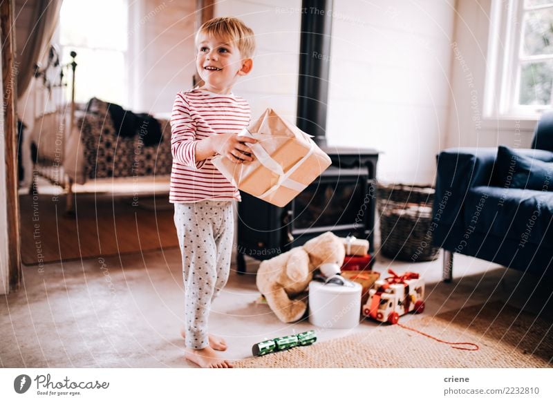 Excited little boy with christmas presents at home Joy Happy Child Toddler Boy (child) Infancy 1 Human being 1 - 3 years 3 - 8 years Toys Smiling Laughter Cute