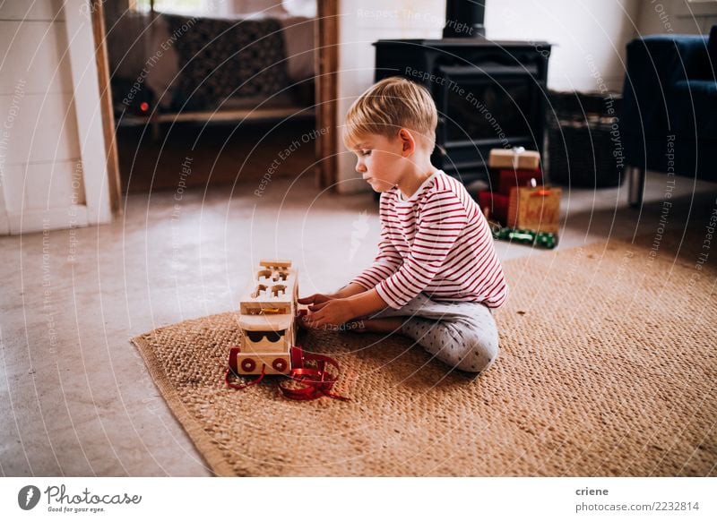 Toddler boy playing with new toy wearing pyjamas Lifestyle Joy Happy Leisure and hobbies Playing Winter House (Residential Structure) Living room