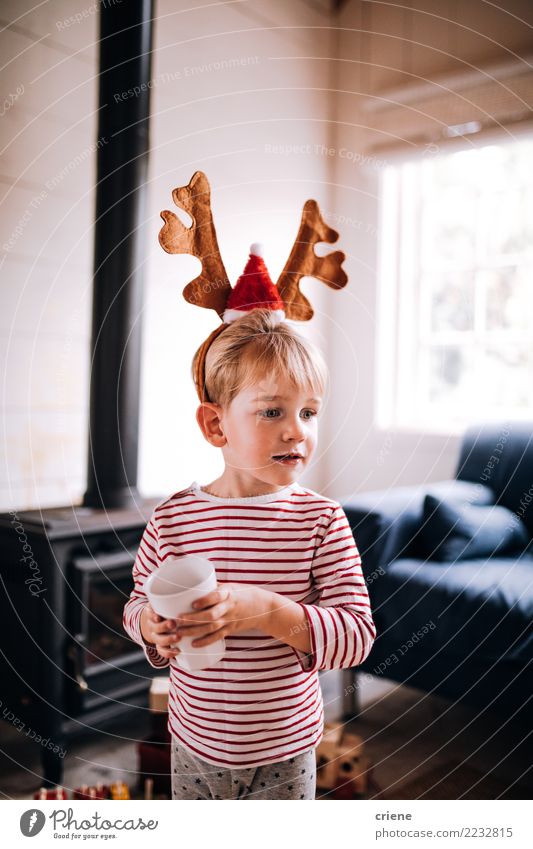 Cute toddler wearing reindeer ear costume on christmas day Drinking Lifestyle Joy Happy Winter House (Residential Structure) Living room Christmas & Advent