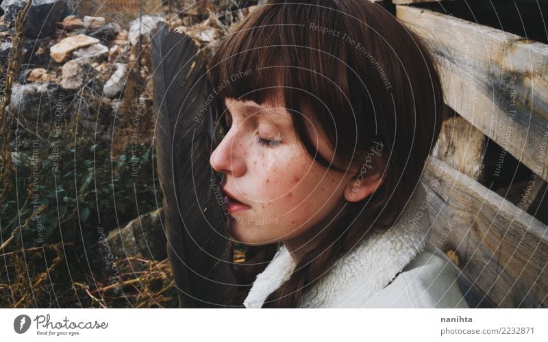 Portrait of a young woman with a huge feather Exotic Beautiful Hair and hairstyles Skin Face Freckles Calm Meditation Human being Feminine Young woman