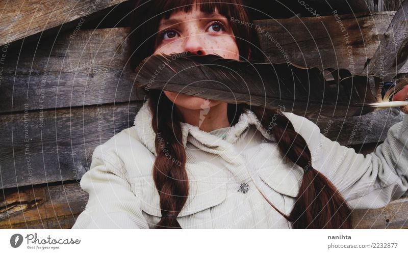 Young woman covering her face with a huge feather Design Exotic Beautiful Hair and hairstyles Skin Face Freckles Human being Feminine Youth (Young adults) 1