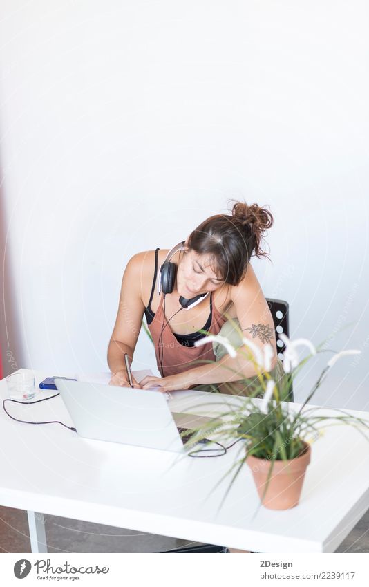 Businesswoman working on her laptop at work ( star-up concept ) Lifestyle Desk Music Success Study Work and employment Office Cellphone Computer Notebook