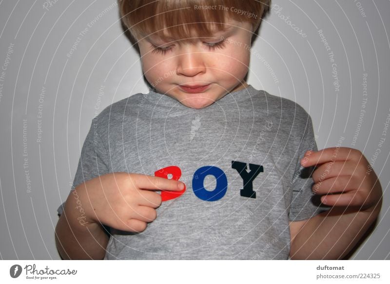 What am I Masculine Child Boy (child) Infancy 1 Human being 3 - 8 years Clothing T-shirt Characters Observe Think Reading Looking Growth Brash Curiosity Cute