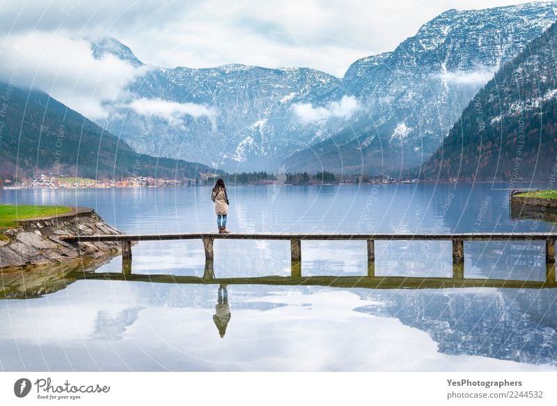 Woman on a deck over an alpine lake Vacation & Travel Tourism Freedom Mountain Human being Young woman Youth (Young adults) Adults 1 Nature Lake Bridge Think