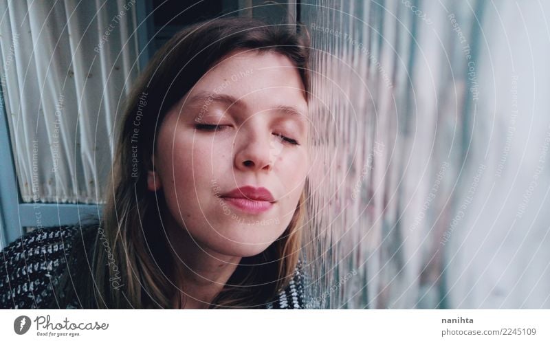 Young happy woman leaning against a window Lifestyle Face Wellness Harmonious Senses Relaxation Room Window Human being Feminine Young woman