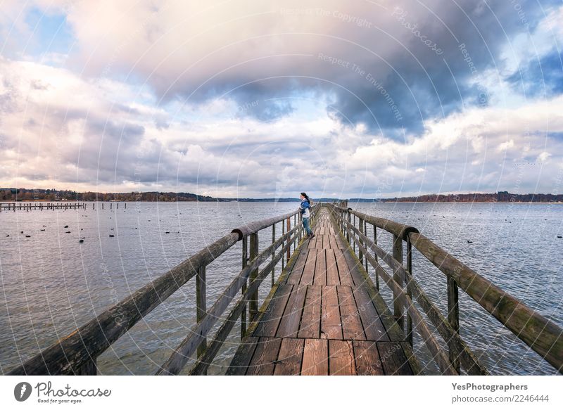 Woman standing on a bridge Vacation & Travel Tourism Freedom Human being Feminine Young woman Youth (Young adults) Adults 1 Nature Horizon Lake Think Loneliness